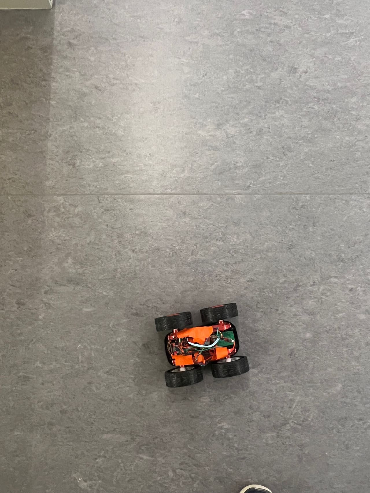 Top-down view of the differential-drive robot on a tiled floor.